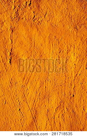 closeup of a rustic orange plastered wall to be used as a background