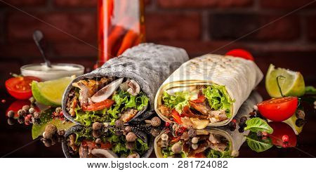 Two Burrito, Black And White Lavash With Chicken, Mushrooms, Salad, Cherry Tomatoes, Lime, And Salsa