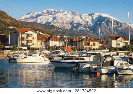 Beautiful Winter Mediterranean Landscape. Fishing Boats In Harbor On Background Of Snowy Mountain Pe
