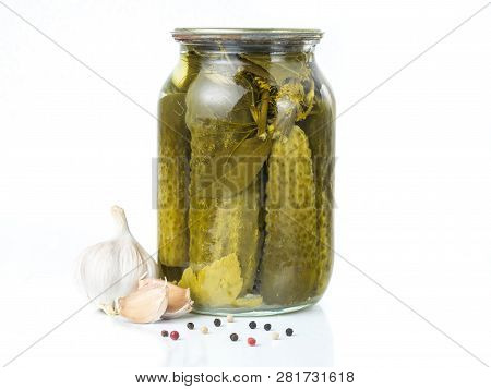 Pickled Cucumbers Isolated. Pickles In Glass Jar With Garlic And Peppercorn Isolated On White Backgr