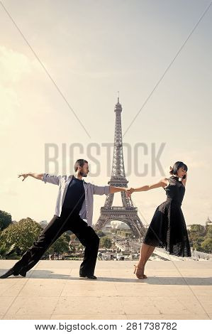 Dance Couple In Front Of Eifel Tower In Paris, France. Beatuiful Ballroom Dance Couple In Dance Pose