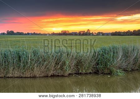 Landscape Close Up Scene Over River At Sunset In Flat Agricultural Area In Groningen Province The Ne