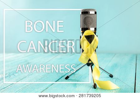 Yellow Ribbon Symbolic Color For Sarcoma Bone Cancer Awareness And Suicide Prevention On Aged Wood W