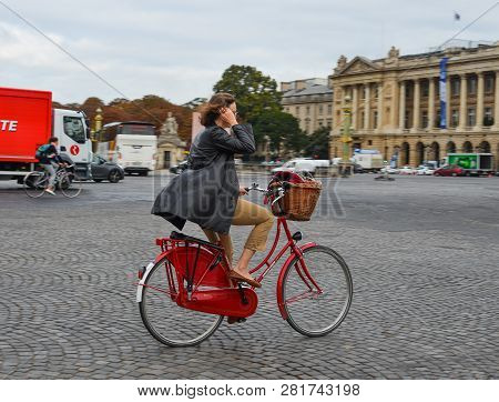 Woman Biking On Street Of Paris, France