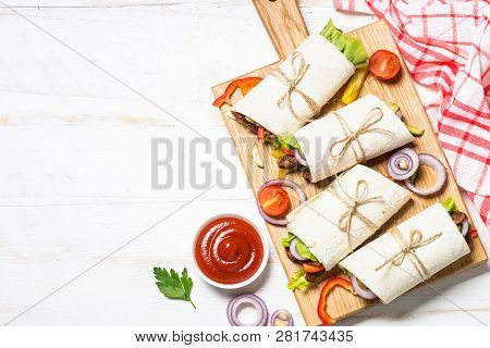 Burritos Tortilla Wraps With Beef And Vegetables On White Wooden Table.  Traditional Latin American 