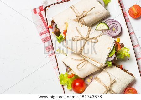 Burritos Tortilla Wraps With Beef And Vegetables On White Wooden Table.  Traditional Latin American 