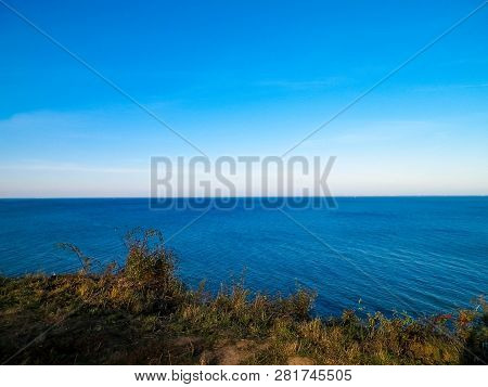 Baltic Sea From Cliff In Mechelinki, Poland. Nature And Travel Concept. Copy Space On Blue Sky.