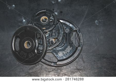 Bunch Of Heavy Black Barbell Weight Plates On The Gym Floor Prepared For Hard Core Fitness Workout S