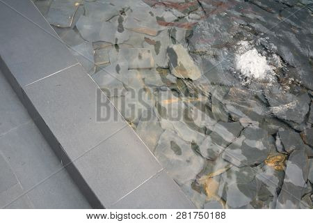 Decorative Fountain Water On Modern Rock Stone Crack Pieces. Ladnscape Design Detail.