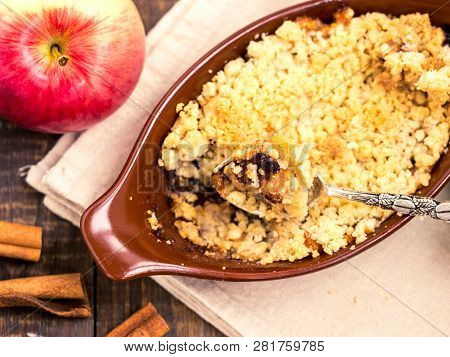 Homemade Apple Cramble Cake With Fresh Apples And Cinnamon Sticks On Rustic Dark Wooden Background. 