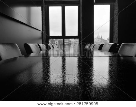 Table And Chairs In A Room With A Window And A View Of The City