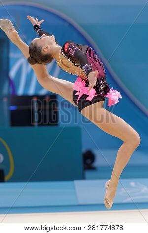 KIEV, UKRAINE - AUGUST 28, 2013: Lucille Chalopin, France performs with ball during 32nd Rhythmic Gymnastics World Championships. The event is held in Palace of Sport