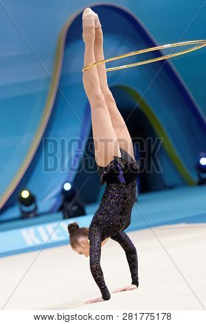 KIEV, UKRAINE - AUGUST 28, 2013: Alina Maksymenko, Ukraine performs with hoop during 32nd Rhythmic Gymnastics World Championships. Eventually she took 5th place