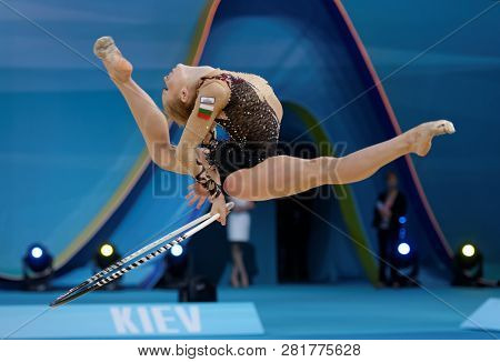 KIEV, UKRAINE - AUGUST 28, 2013: Mariya Mateva, Bulgaria performs with hoop during 32nd Rhythmic Gymnastics World Championships. The event is held in Palace of Sport