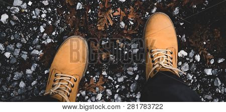 Feet Of Traveler In Boots Standing On Ground, Wide Composition