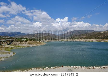 Scenic Landscape Shot Of Germasogeia Dam In Cyprus On A Beautiful Blue Sky Day.  Wind Patterns On Th