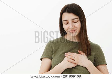 Dreamy Girlfriend Filled With Love Close Eyes And Smiling Tender As Holding Palms On Heart Feeling H