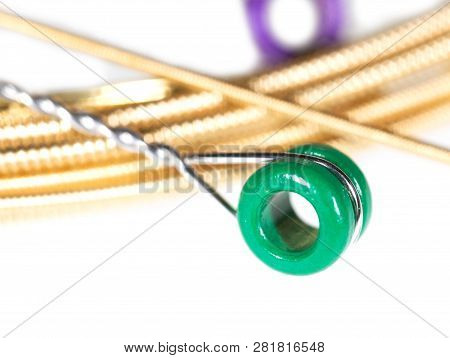 Strings For Guitar Isolated On A White Background. Macro