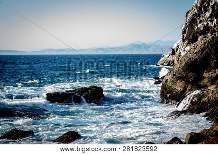 Some Waves Hitting The Rocks On A Warm Summer Day. Beautiful Beach View At Moro Rock In California.