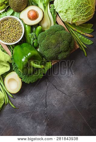 Assorted Green Toned Raw Organic Vegetables On Dark Background. Avocado, Cabbage, Broccoli, Cauliflo