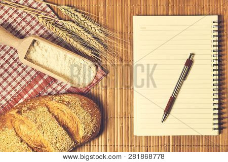 Bakery Food And Notebook On The Table