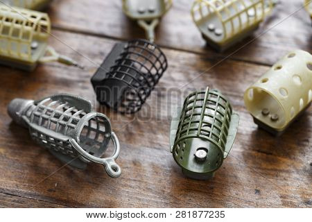 Necessary Accessories For Feeder Fishing On A Wooden Board. Feeder Feeders Side View.