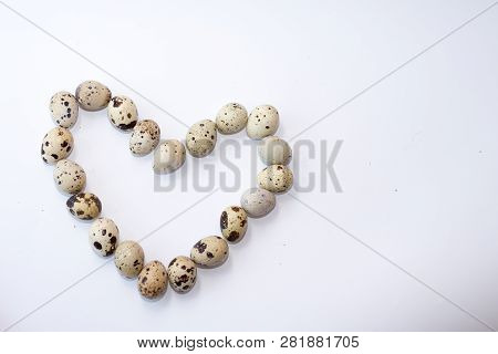 Quail Eggs Isolated On White . Easter Background . Heart Of Eggs