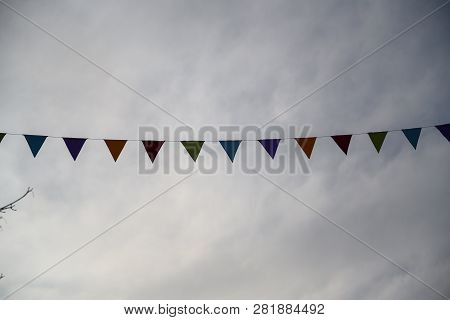 Festival Garlands In Front Of A Drab Gray Sky