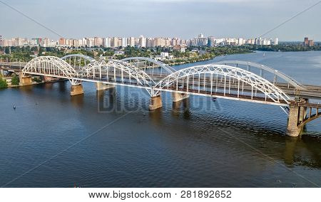 Aerial Top View Of Automobile And Railroad Darnitsky Bridge Across Dnieper River From Above, Kiev (k