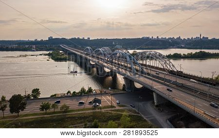 Aerial Top View Of Automobile And Railroad Darnitsky Bridge Across Dnieper River From Above, Kiev (k