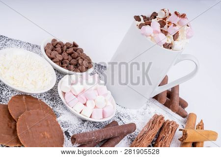 Mug Of Hot Chocolate Topped With Whipped Cream Marshmallows And Chocolate Drops With A Selection Of 