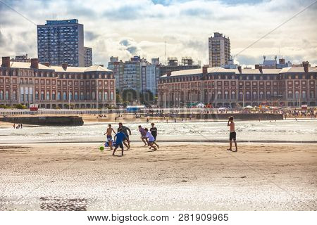 Mar Del Plata, Argentina - 26 Octubre, 2018: Children playing football on the shores of the Atlantic Ocean