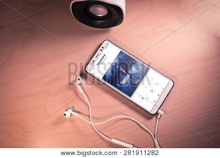 Top View Image Of Smartphone, Earphones And Speaker With Bluefaces Song On Screen