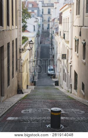 Long And Narrow Street In Chiado Lisbon, Portugal. Elevation, Ramp, Hill Going Up And Down. Slope Wi