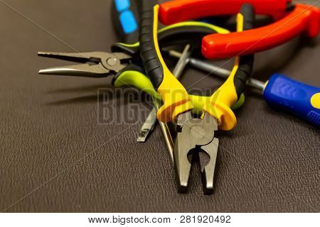 Pile Of Wire Cutters Screwdriver Closeup Of Pliers Lots Of Hand Tools Grunge Style On Dark Backgroun
