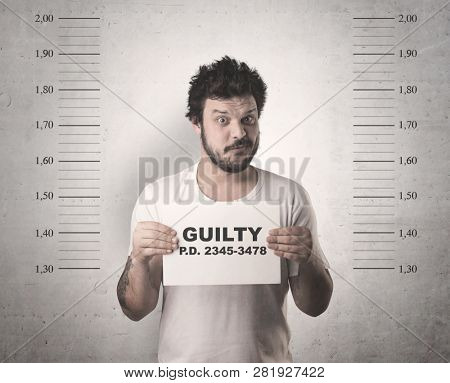 Caught guilty man with ID signs on his hand.