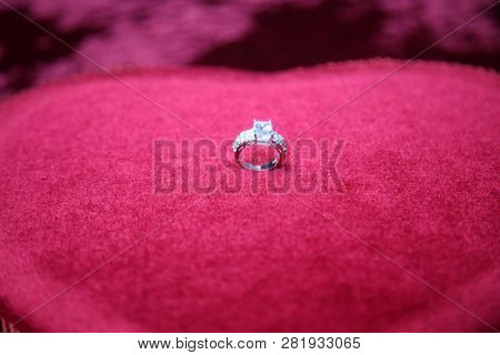 Wedding Ring. Wedding or Engagement ring on a Red Velvet Valentines Day Heart Shaped box of candy. 
