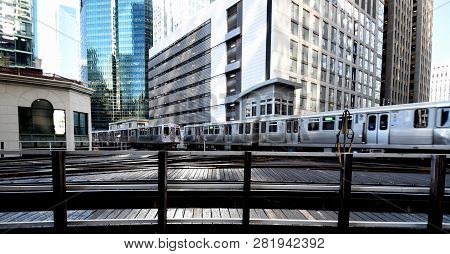 Two Commuter Trains Passing One Another On An Elevated Train Track Railroad Track Interchange Surrou