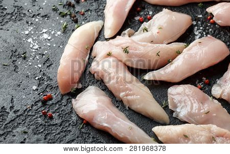 Raw Chicken Breast Mini Fillets In Rastic Cast Iron Skillet, Frying Pan With Herbs And Sea Salt