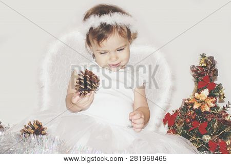 Little Child In The Costume Of An Angel. Selective Focus.