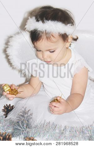 Little Child In The Costume Of An Angel. Selective Focus.