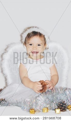 Little Child In The Costume Of An Angel. Selective Focus.