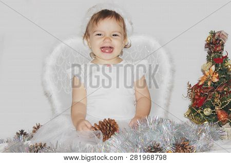 Little Child In The Costume Of An Angel. Selective Focus.