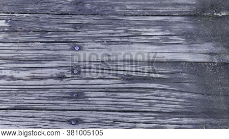 A Background Of Weathered Planks.  Deep Grained Wood Pattern.  Primarily Black In Color, Row Of Nail