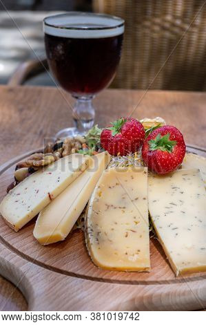 Tasting Of Different Belgian Cheeses And Dark Strong Belgian Beer Served Outdoor Close Up