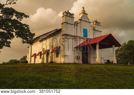 As Monsoon Clouds Roll-in On The Three Kings Chapel With Portuguese Architectural Design, On A Hill 
