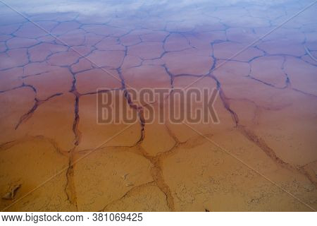 Poisonous water with cracked soil on abandoned territory with catastrophic environmentall situation that is absolutely unusable for full-fledged life