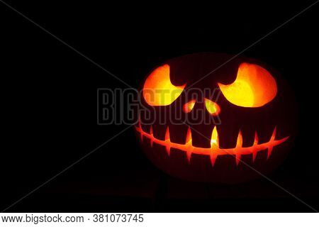 Ghastly Halloween Pumpkin Head Jack Lantern On Black Background