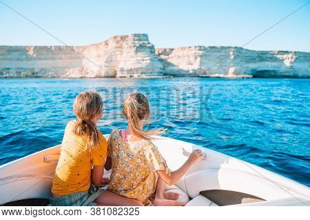 Little Girls Sailing On Boat In Clear Open Sea