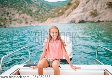 Little Girl Sailing On Boat In Clear Open Sea
